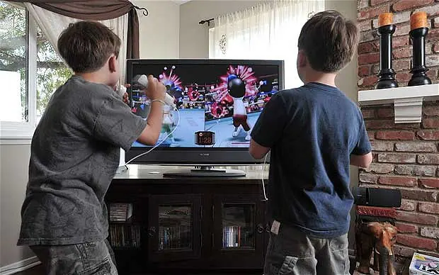A group of friends enjoying a Nintendo Wii boxing game together.